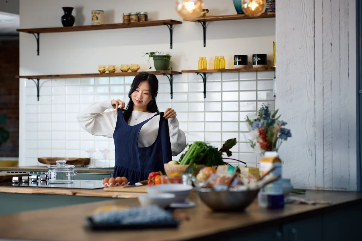 Making time for a meal in a Hanee navy apron